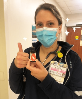 Nurse holding a bottle of Immune Strength Essential Oil