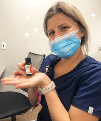 Nurse holding a bottle of Immune Strength Essential Oil